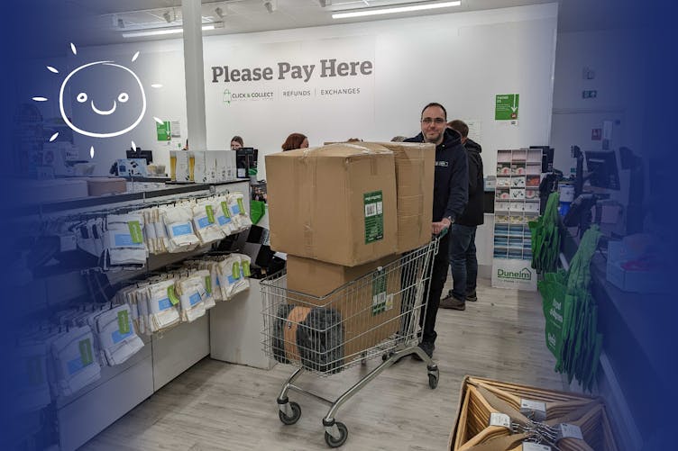 David with shopping trolly overflowing with boxes filled with essential items for Ukraine bought with last-minute donations 