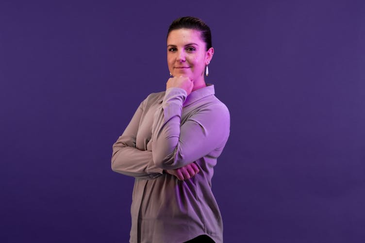 Cara in front of a Gravity Works purple background