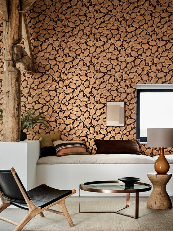 Country-style home with orange and burgundy leaf-printed wallpaper (Beech Nut - Cordoba) and thick wooden ceiling beams.