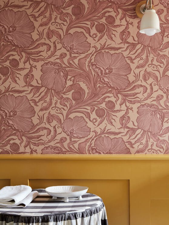 Close-up of National Trust pink floral wallpaper (Poppy Trail - Masquerade) on the upper wall and yellow (Yellow-Pink) below.