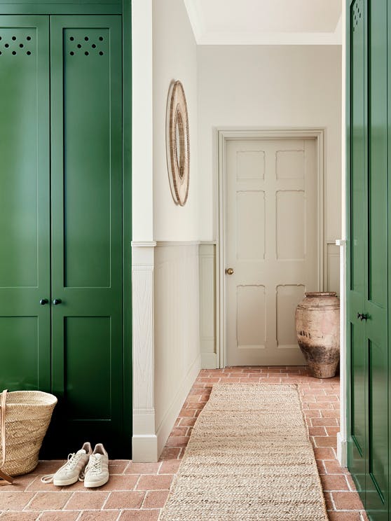 Hallway with various Portland Stone shades on the walls and ceiling, alongside a dark green (Dark Brunswick Green) cupboard.