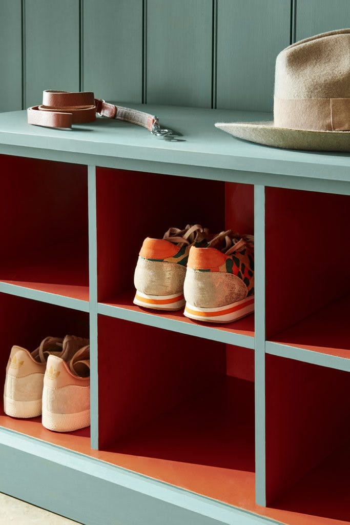 Close-up of shoe shelves and paneling in the green shade, Pleat, and primed with Little Greene Intelligent ASP.