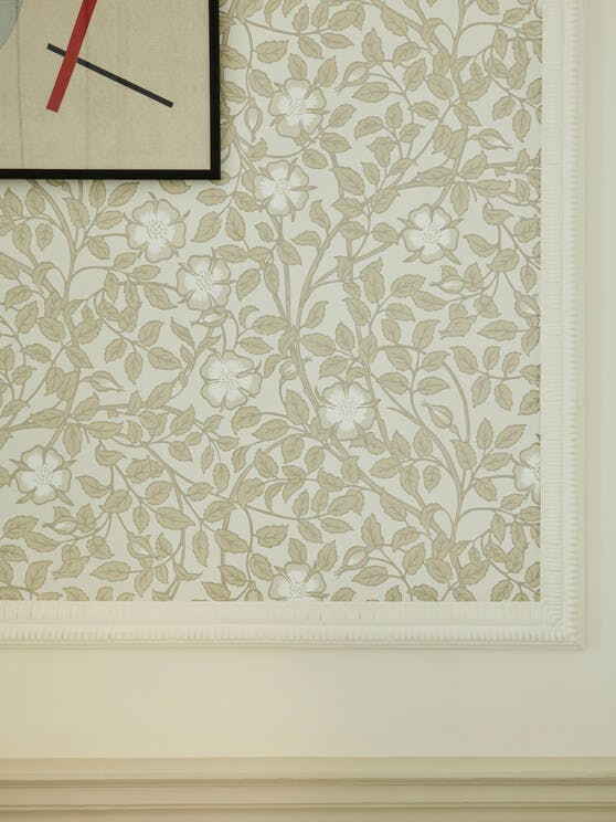 National Trust neutral green floral wallpaper (Briar Rose - Grene Stone) surrounded by neutral green paint on walls.