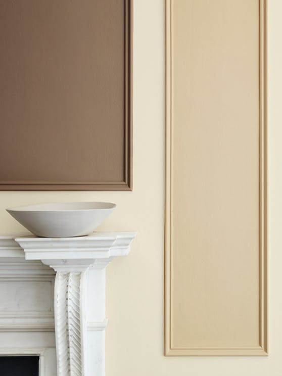 Close-up of a neutral beige (Clay - Mid) wall with detailed paneling in deep stone, pale brown and fawn colors.