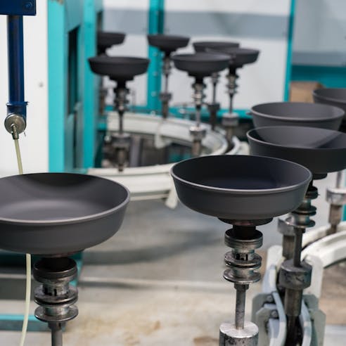 Production line of non-stick cookware. Image Credit: Shutterstock.com/Akimov Igor