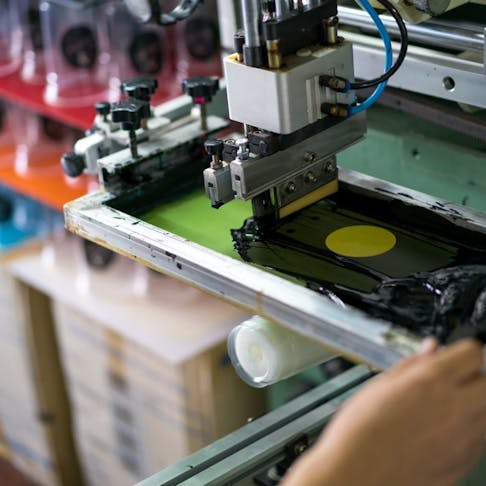 Plastic Cup Silk Screen Printing Machine. Image Credit: Shutterstock.com/KOKTARO