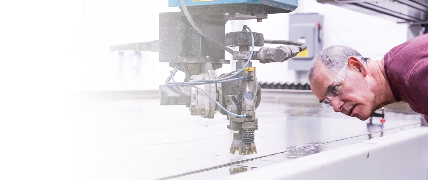 Man viewing a CNC machine