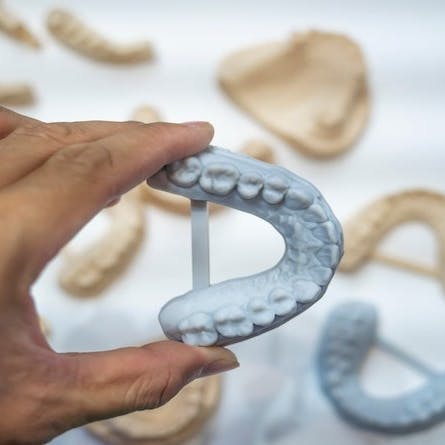 Dental technician modeling frame for implant production from a 3d printer.