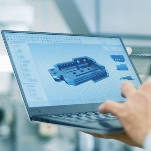 Engineer looking at a CAD design on a laptop. Image Credit: Shutterstock.com/Gorodenkoff