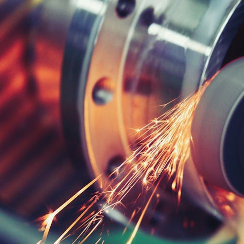 Grinding and finishing metal. Image Credit: Shutterstock.com/NDAB Creativity