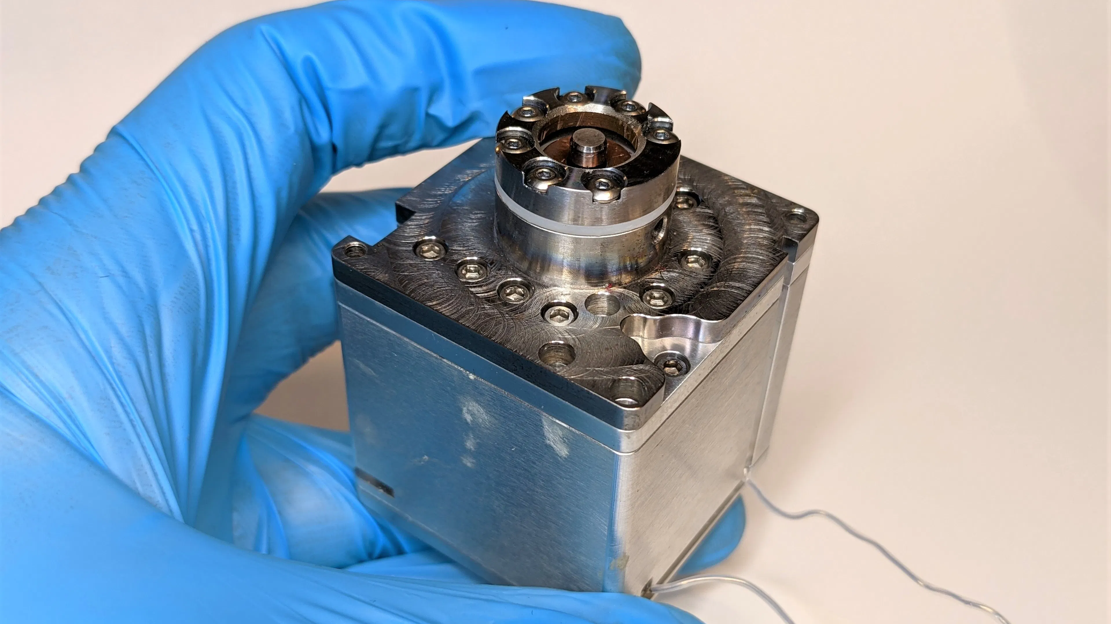 The thruster in a gloved hand