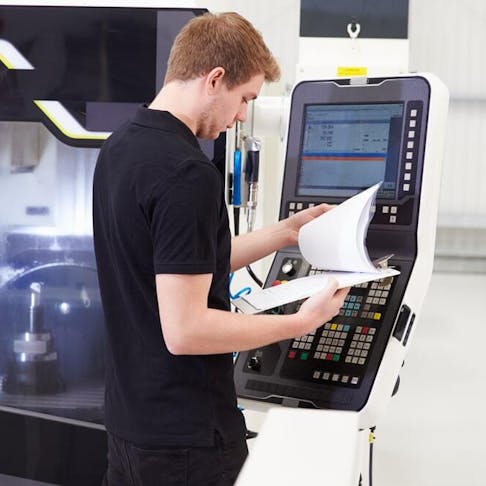 Machinist operating a CNC machine. Image Credit: Shutterstock.com/Monkey Business Images