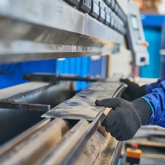 Sheet metal in hydraulic press brake. Image Credit: Shutterstock.com/Dmitry Kalinovsky