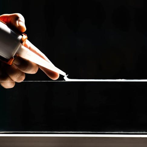 Silicone adhesive in use. Image Credit: noprati somchit/Shutterstock.com