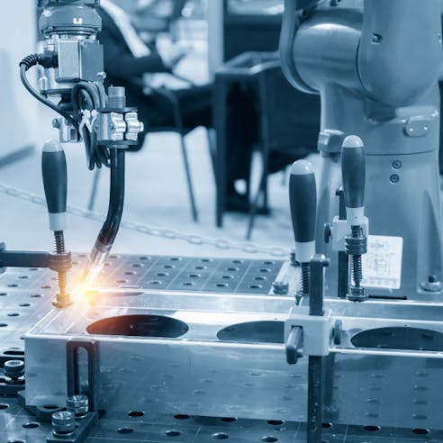 Welding robot machine for welding automotive parts. Image Credit: Shutterstock.com/Pixel B
