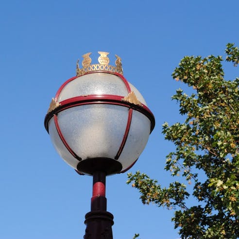 Globe lens on a street lamp fixture. Image Credit: Stephen Whybrow/Shutterstock.com
