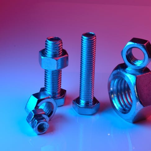 Titanium anodized nuts and bolts. Image Credit: Shutterstock.com/L-51