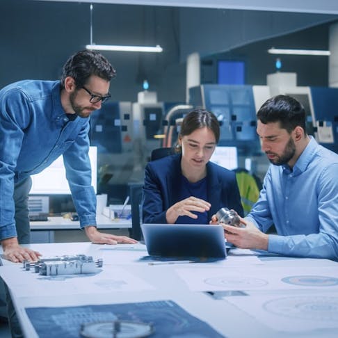 A group of engineers discussing designs. Image Credit: Gorodenkoff/Shutterstock.com