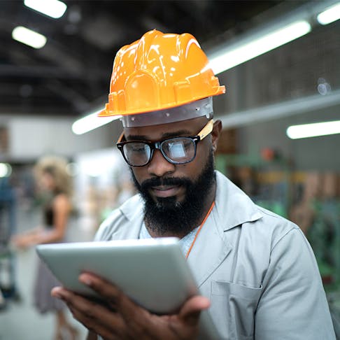 man looking at tablet. Image Credit: Stock.Adobe.com/FG Trade