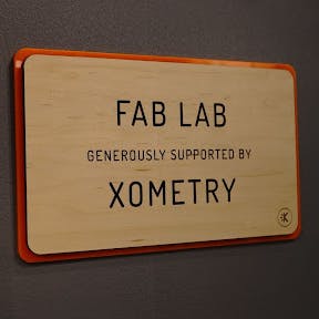 A plaque saying "Fab Lab - Generously Supported by Xometry