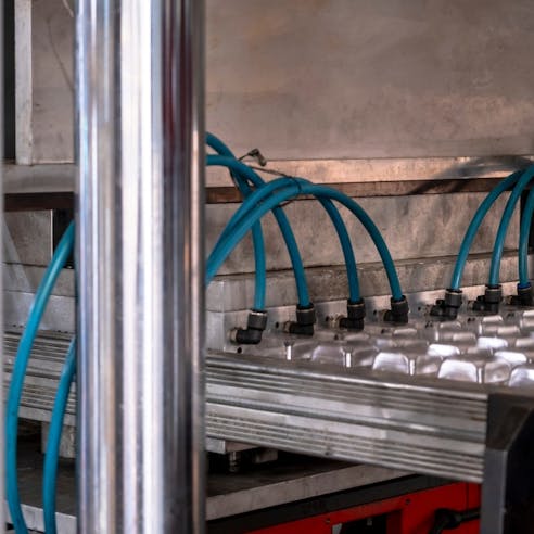 Vacuum thermoforming in factory. Image Credit: Shutterstock.com/Yasin Caglayan