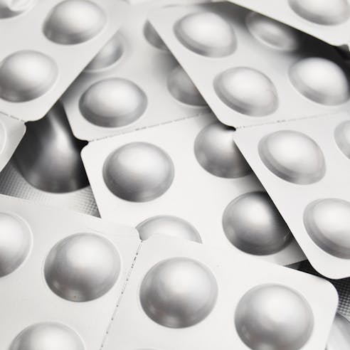 Tablets in silvery blisters up close. Image Credit: Shutterstock.com/Vladimir Sukhachev