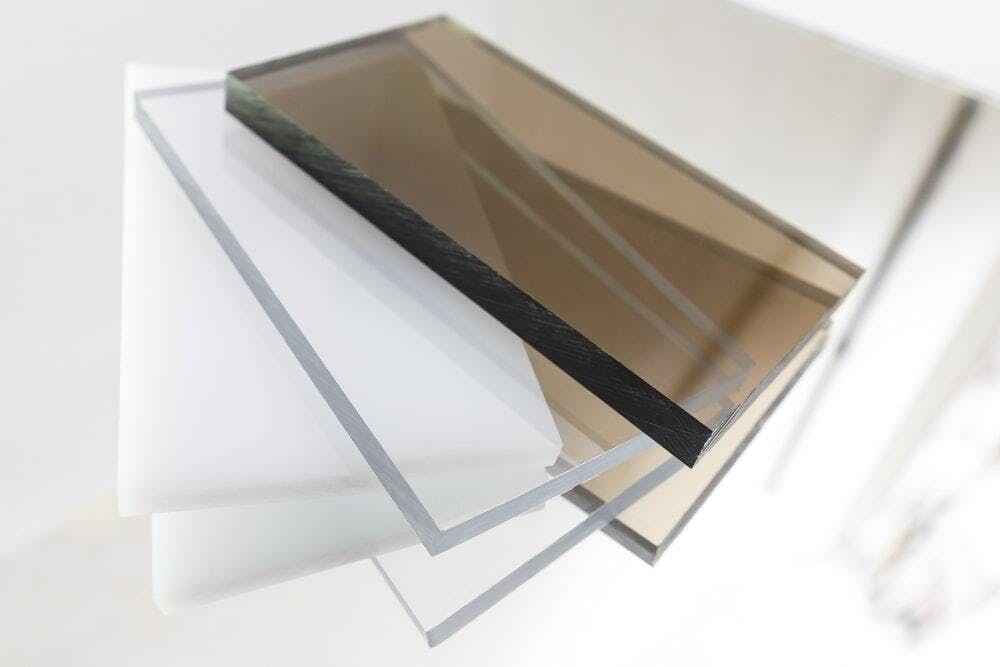 Solid brown, white, and transparent polycarbonate sheets.
