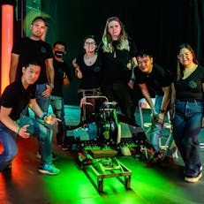 Jamison Go posing with his team and Battlebot