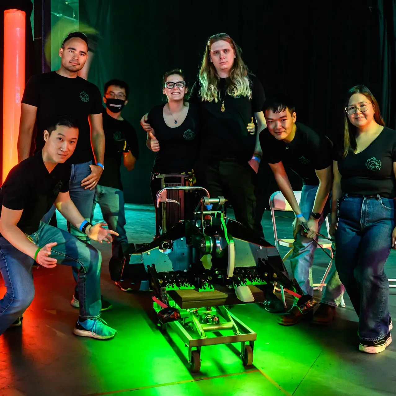 Jamison Go posing with his team and Battlebot