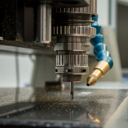 Engraving onto a metal surface using a mechanical cutting blade. Image Credit: szelltib/Shutterstock.com