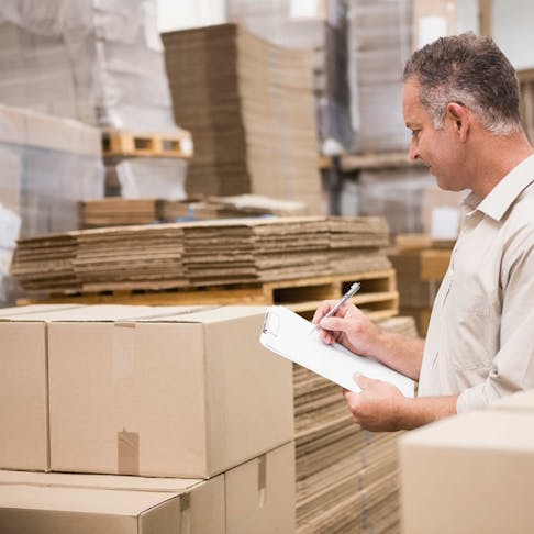 Warehouse worker checking inventory in the demand planning process.