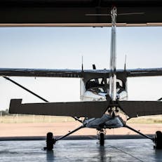 propeller aircraft rear view in a hangar