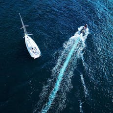 A sailboat and a fast boat on the ocean