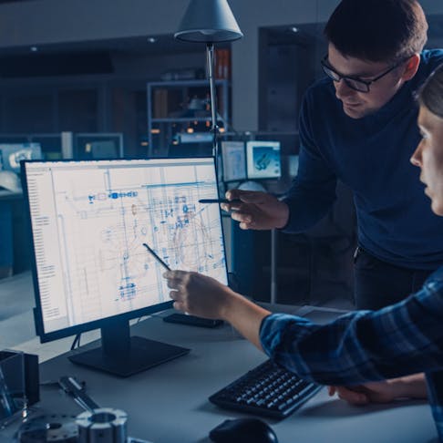 Engineers working with CAD software. Image Credit: Shutterstock.com/Gorodenkoff