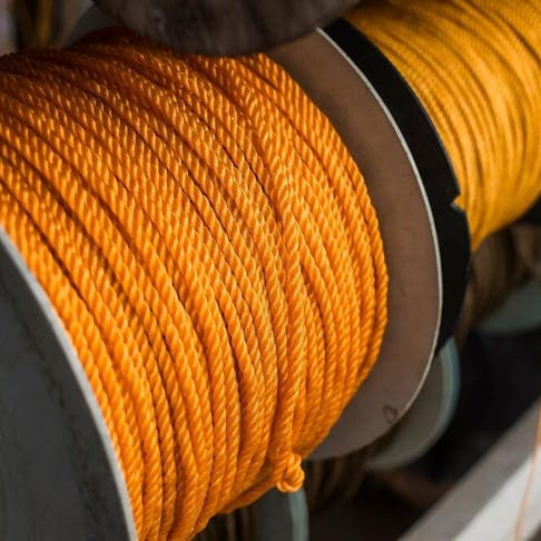 Spools of yellow polyethylene nylon ropes. Image Credit: MDV Edwards/Shutterstock.com