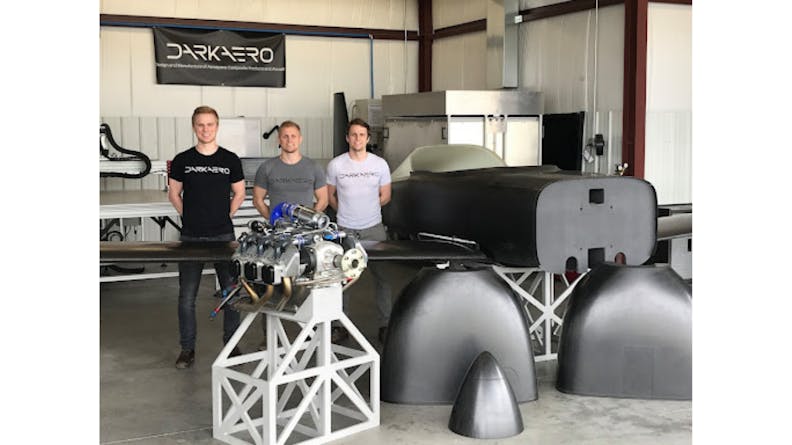 The Karl brothers standing in their shop alongside the DarkAero 1 prototype and it's engine
