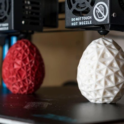 Dual extruder 3d printer printing two objects. Image Credit: Shutterstock.com/Reflexpixel
