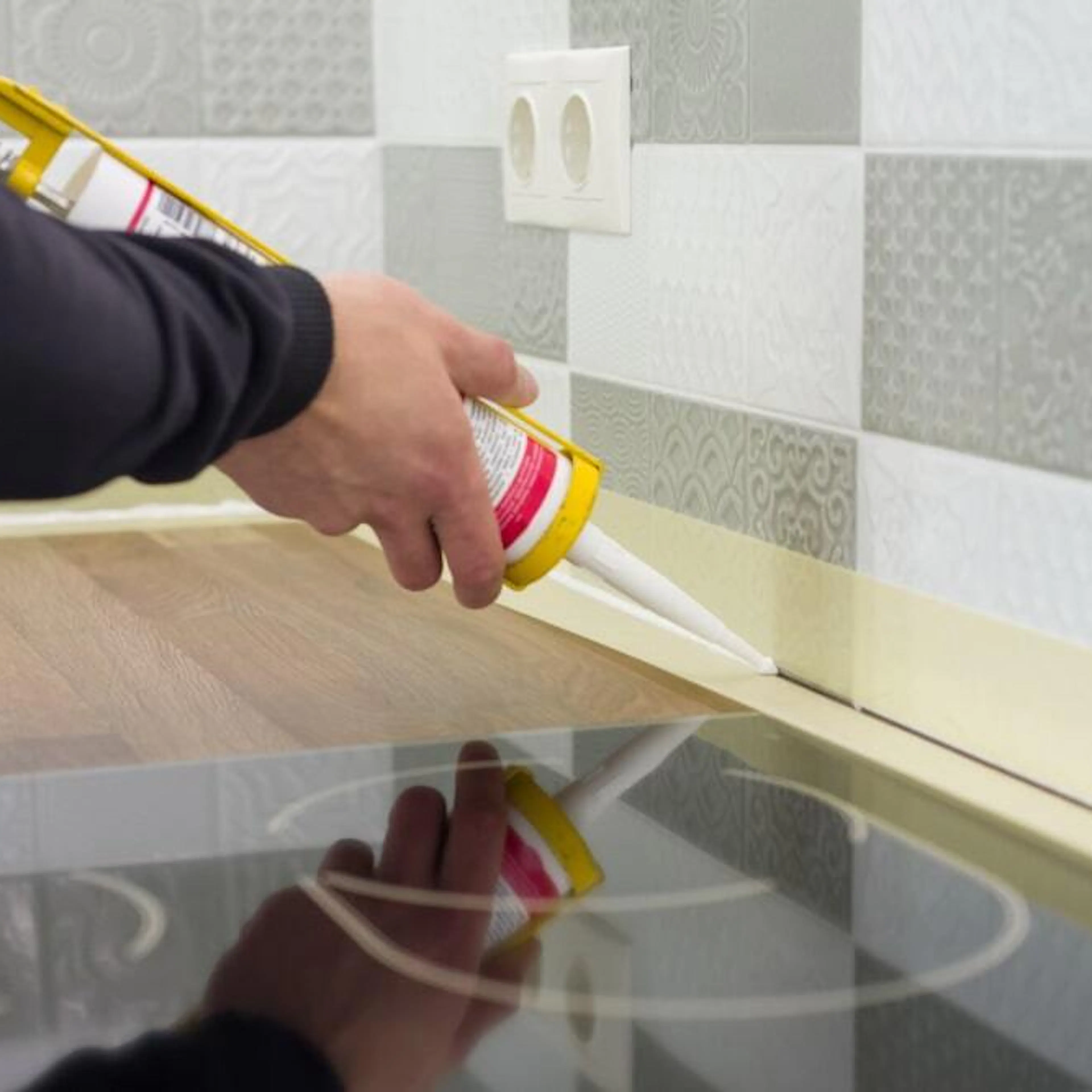 Applying silicone sealant with construction syringe. Image Credit: Shutterstock.com/VH-studio