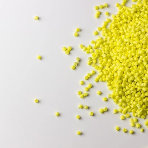 Yellow granules of polypropylene on a white background. Image Credit: Anastasiia Burlutskaia/Shutterstock.com