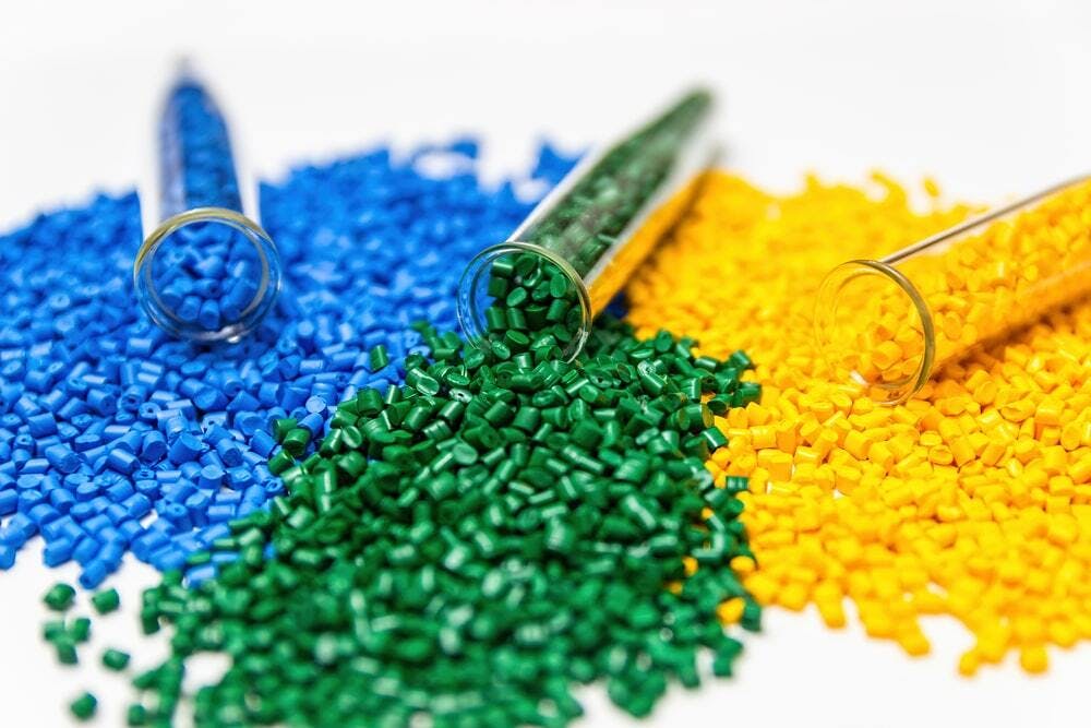 thermoplastic pellets in blue, green, and yellow