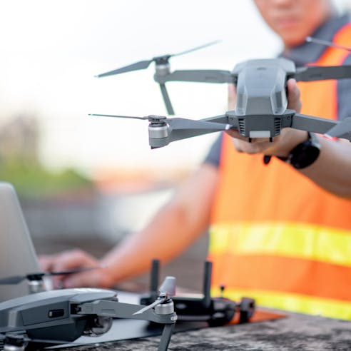Young engineer working with drone laptop. Image Credit: Shutterstock.com/Zephyr_p