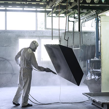 Worker Bead Blasting a Metal Box