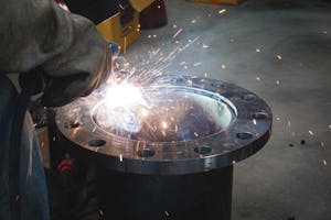 Welder is welding a flange assembly. Image Credit: Shutterstock.com/Chumphon_TH