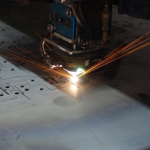 CO2 laser cutting through stainless steel. Image Credit: Shutterstock.com/kittinun kongsuebchat