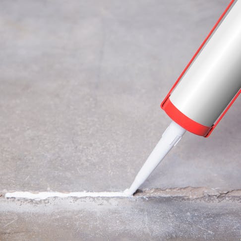 Sealing a crack with silicone. Image Credit: Shutterstock.com/Dimik_777