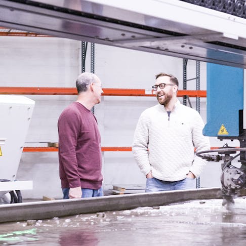 The Xometry team by a waterjet