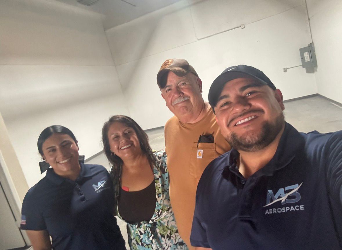 Working with Xometry has allowed Sebastian Montalvo and Sergio Montalvo to expand their shop.  They are pictured above with Sebastian's wife and Sergio's partner in M3 Aerospace's newest space, which added 2,000 square feet to their facility. (Image Credit: M3 Aerospace)