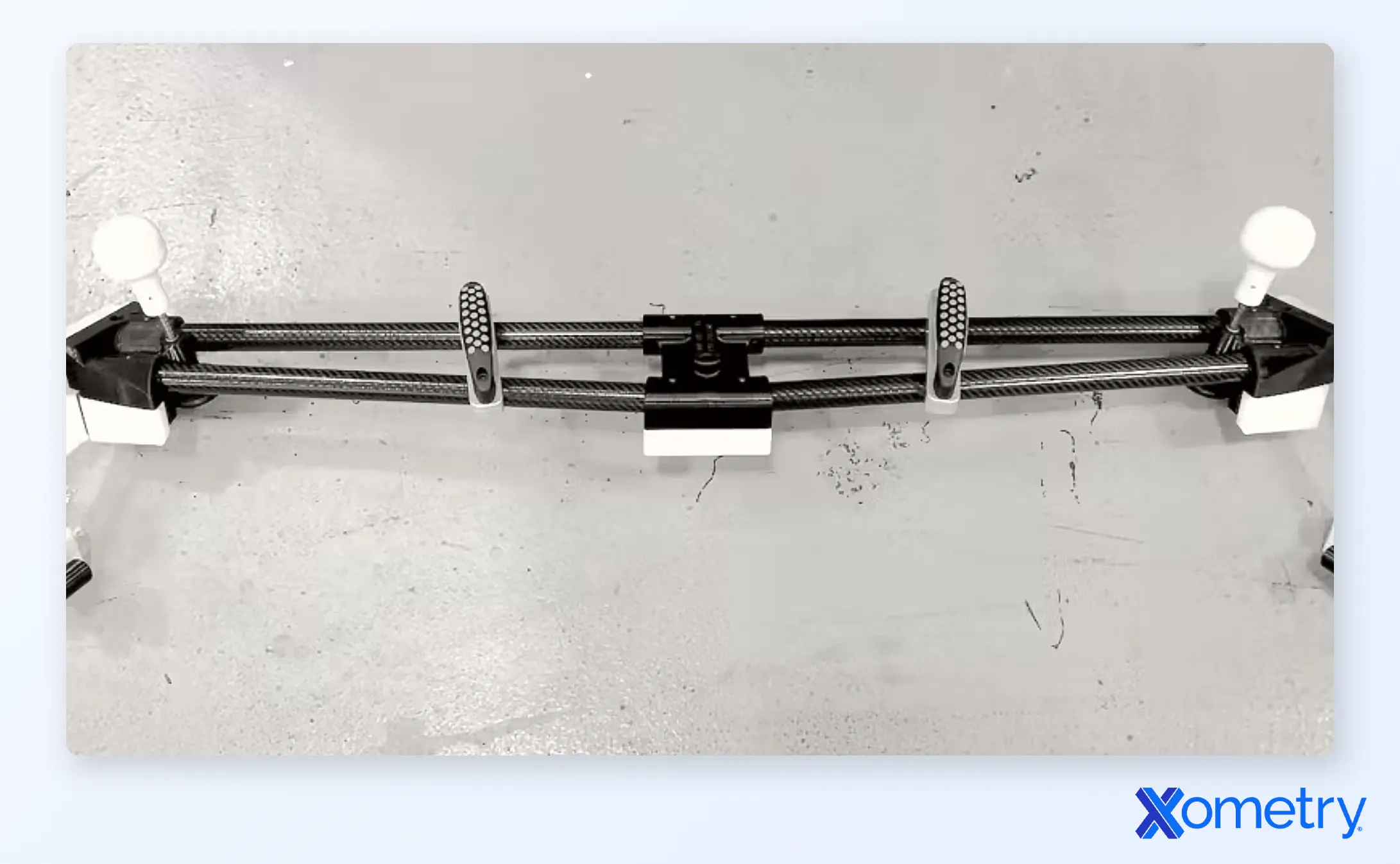 A Xometry-manufactured fixture used for alignment of the vehicle back end during assembly processes. The fixture is made up of cut carbon fiber tubing, CNC machined plastic and metal parts, and 3D printed Ultem components made by Xometry.