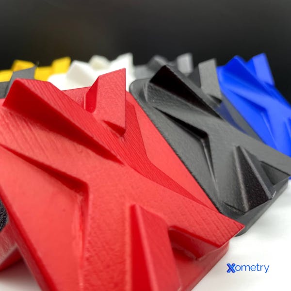 Array of 3D printed vapor smoothed parts dyed various colors