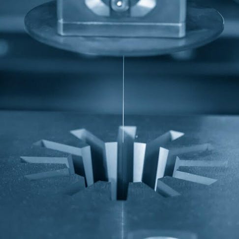 A wire EDM machine cutting a gear shape. Image Credit: Shutterstock.com/Pixel B